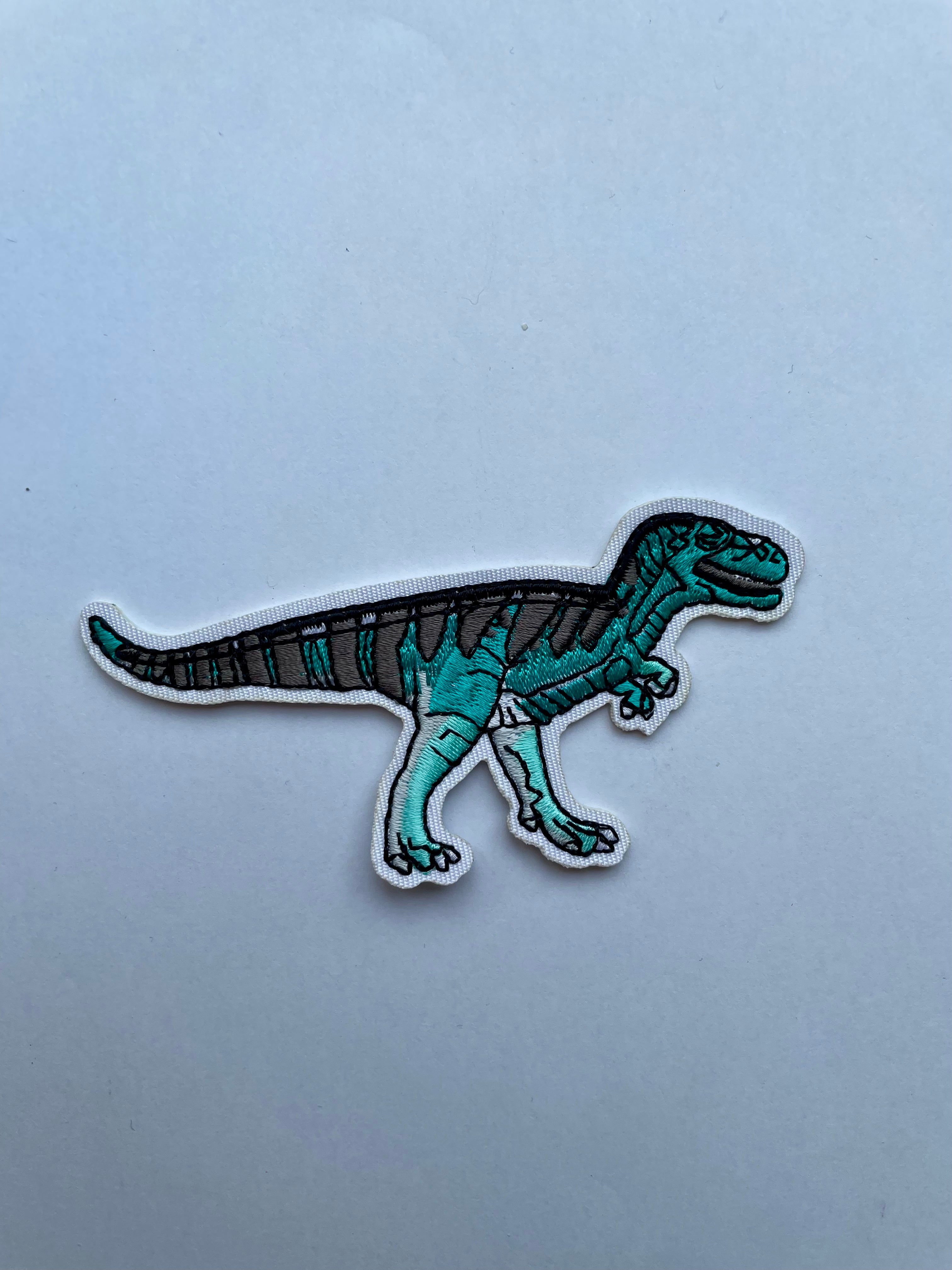 T- rex kangasmerkki turkoosi